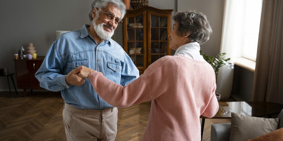 medium-shot-smiley-couple-dancing-home (1)
